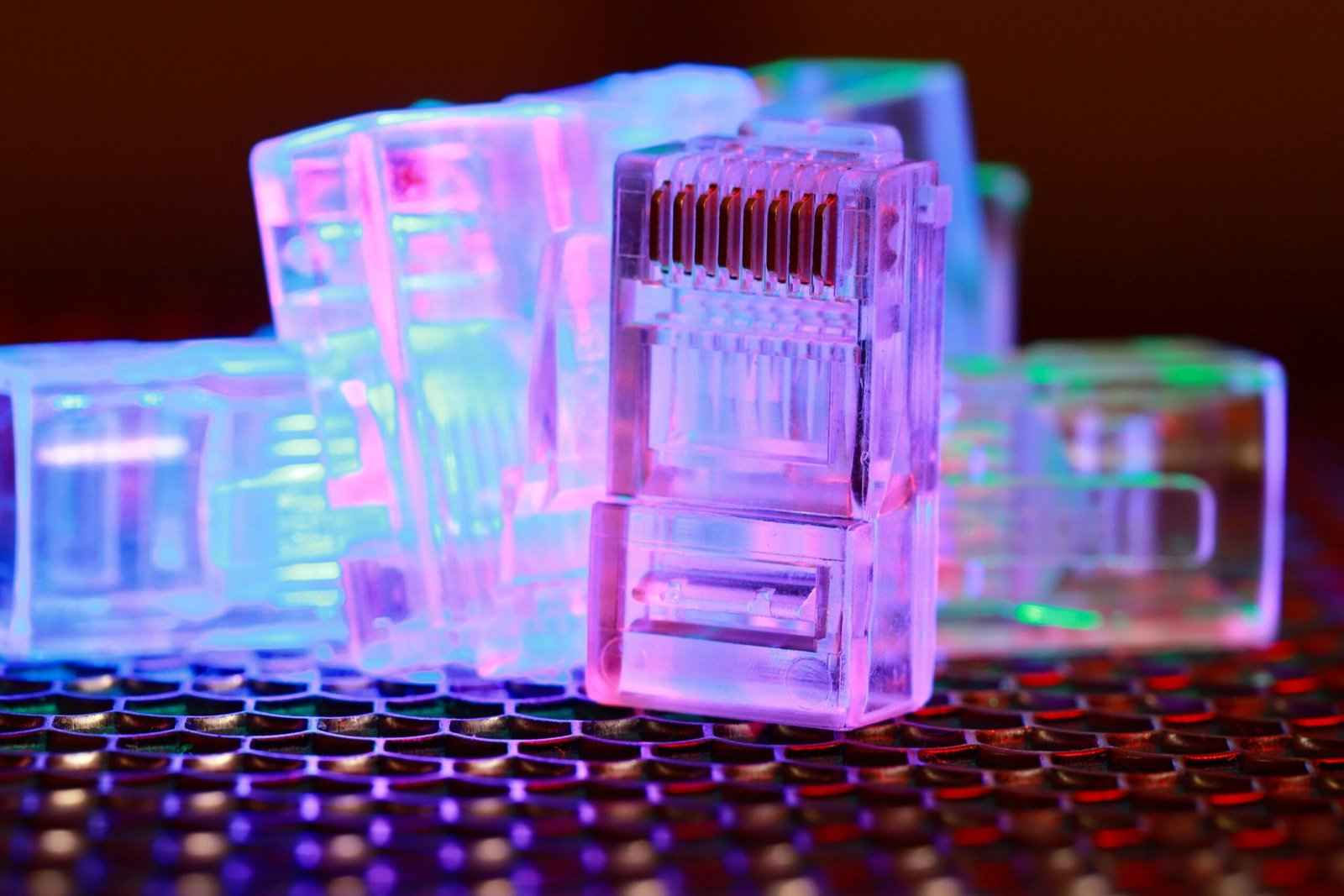 Vibrant close-up of network cable connectors with colorful lighting.